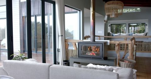 Contemporary Living Room with Cozy Fireplace and Panoramic Windows - Download Free Stock Images Pikwizard.com
