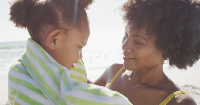 Mother Wrapping Child in Towel at Beach on Sunny Day - Download Free Stock Images Pikwizard.com