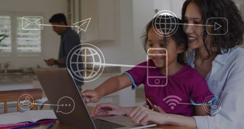 Mother guiding daughter on laptop with digital connectivity icons for online learning