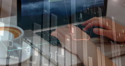 Hands Typing on Laptop with Financial Data Graphs Overlay