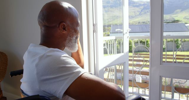 Senior Man in Wheelchair Looking Out Window in Natural Light - Download Free Stock Images Pikwizard.com