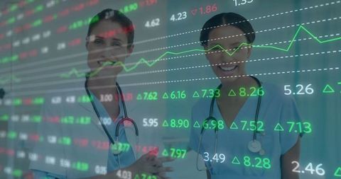 Smiling Medical Professionals Analyzing Financial Trends in Hospital Corridor
