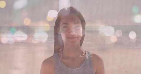 Serene Portrait of Woman on Sandy Beach with Artistic Bokeh Lights
