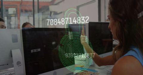 Woman authenticating access via fingerprint scanner in office