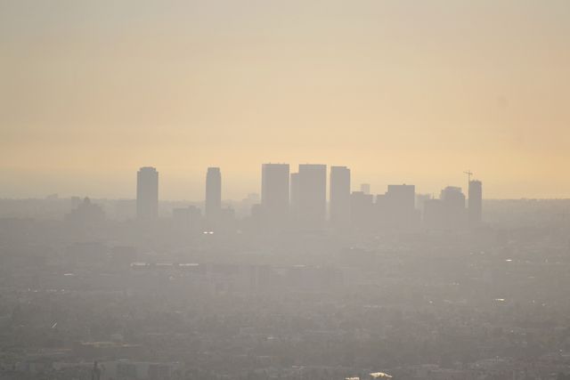 Smog-covered downtown skyline during sunrise - Download Free Stock Photos Pikwizard.com
