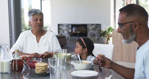 Family Sharing Breakfast Moment in Modern Sunlit Kitchen