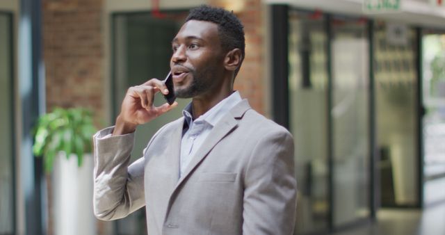 Confident Businessman Having Phone Call in Office - Download Free Stock Images Pikwizard.com