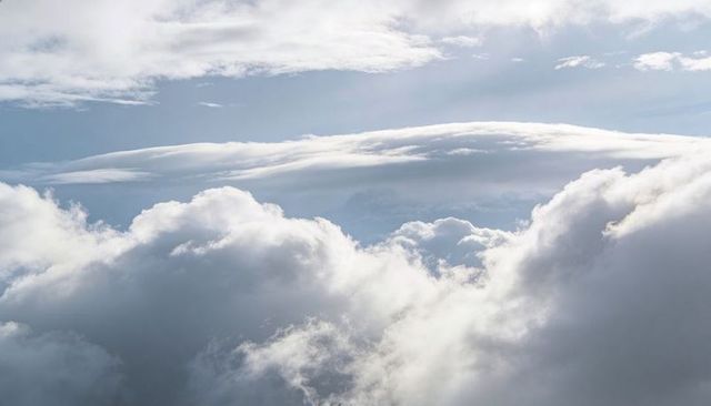 Billowing Cumulus Clouds with Lenticular Bands Creating Tranquil High-Altitude Skyscape