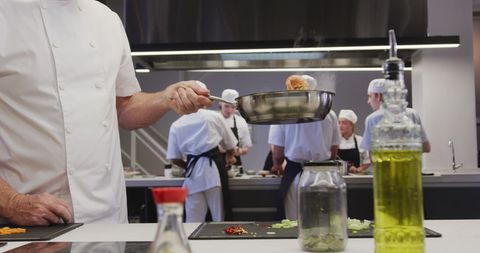 Chef Flipping Pancake in Culinary School Kitchen Setting - Download Free Stock Images Pikwizard.com