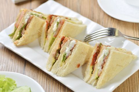 Club Sandwich Triangles Featuring Bacon, Lettuce, Tomato and Mayo on White Bread Platter
