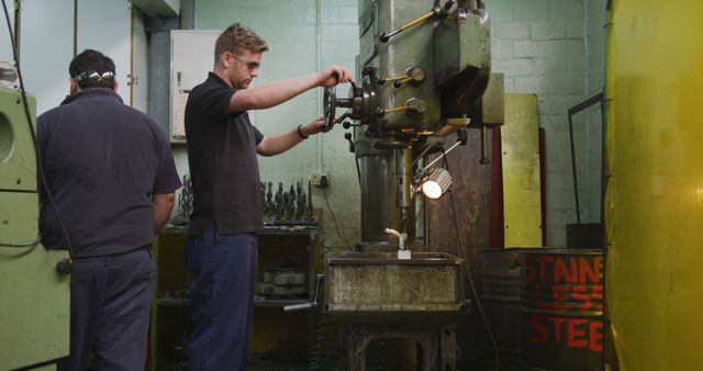 Engineers Working in Machine Shop Using Drill Press - Download Free Stock Images Pikwizard.com