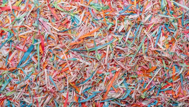 Pastel Shredded Paper Confetti Pile Creating Layered Abstract Texture with Curled Ribbon Pattern
