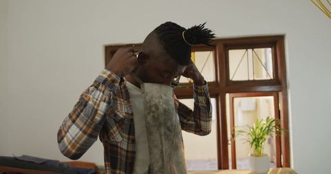 African American Craftsman Preparing Apron in Workshop