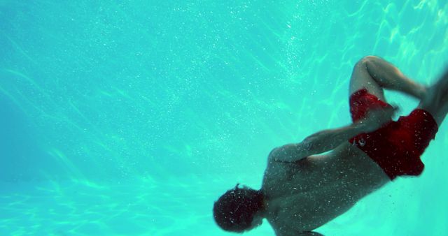 Male Diver Underwater in Swimming Pool with Sunlight Reflections - Download Free Stock Images Pikwizard.com