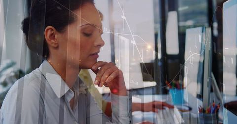 Businesswoman Focusing on Financial Data with Advanced Graph Interface