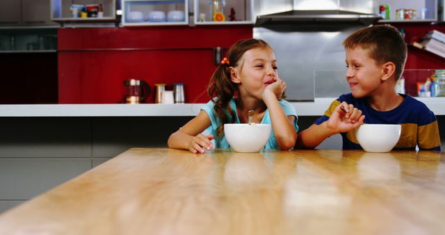 Happy Siblings Enjoying Breakfast in Modern Kitchen - Download Free Stock Images Pikwizard.com