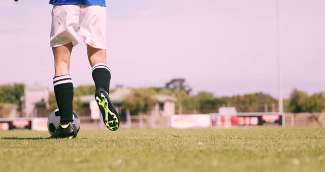 Young Soccer Player Dribbling Ball on Field - Download Free Stock Images Pikwizard.com