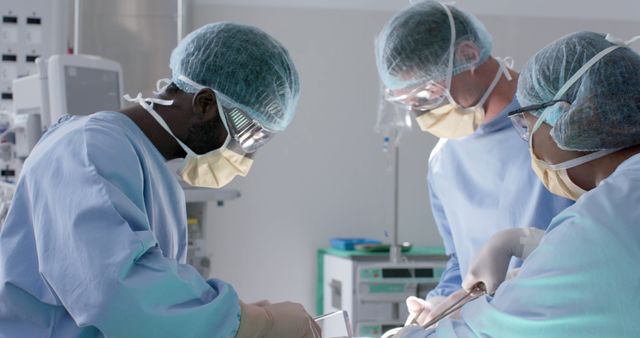 Diverse male and female surgeons with face masks during surgery. Medicine, healthcare and hospital, unaltered.