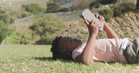 Boy with Tablet Enjoying Learning Outdoors in Nature