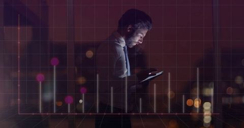 Businessman Analyzing Data on Tablet Over City Lights with Graph overlay