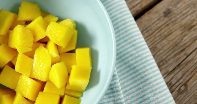 Fresh Mango Cubes in Light Blue Bowl on Wooden Table - Download Free Stock Images Pikwizard.com