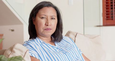 Woman Relaxing in Contemporary Living Room with Glass Elements