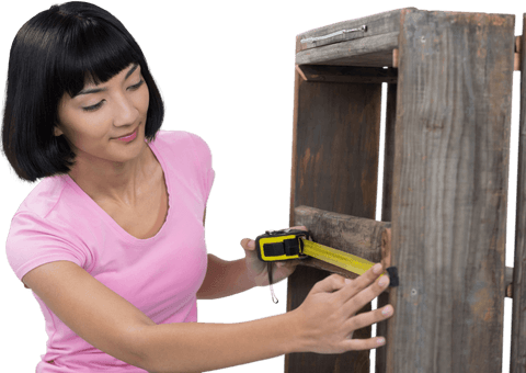 young woman measuring wooden furniture piece with tape under transparent background - Download Free Stock Videos Pikwizard.com