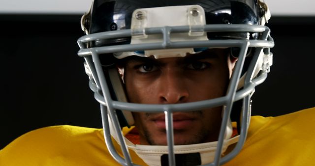 Determined Football Player in Helmet and Yellow Jersey - Download Free Stock Images Pikwizard.com