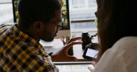 Graphic designers collaborating at modern office desk