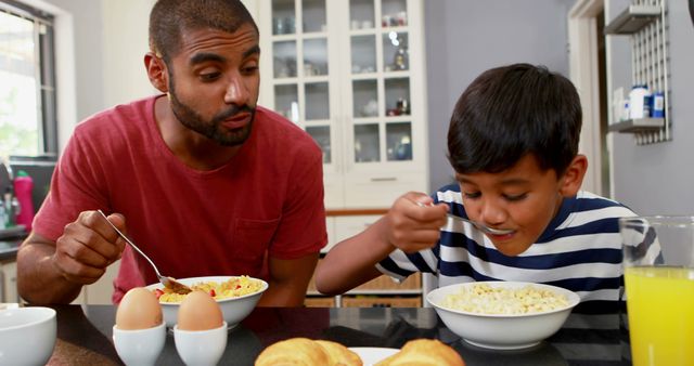 Father and Son Enjoying Breakfast Together in Modern Kitchen - Download Free Stock Images Pikwizard.com