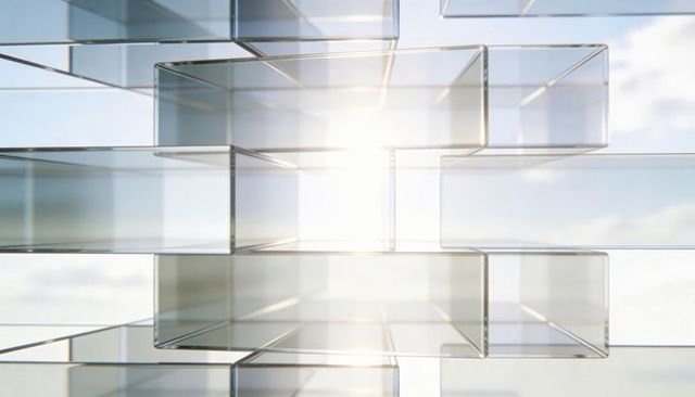 Backlit glass prism cluster refracting sunlight through transparent architectural blocks