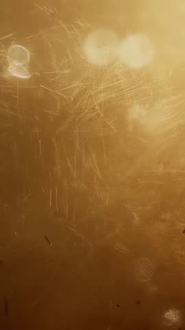 Scratched Gold Panel Emitting Warm Bokeh Highlights Vertical Abstract Texture Video