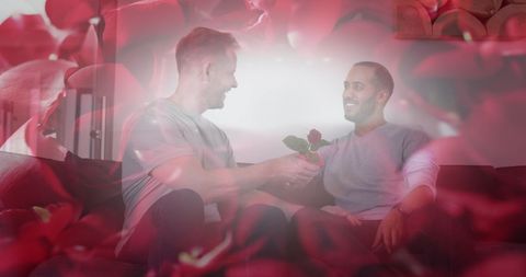 Romantic moment between diverse gay couple with rose petals