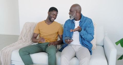 Father and Son Enjoying Quality Time on Sofa
