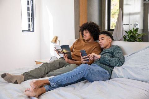 Relaxed Friends Lounging in Modern Bedroom