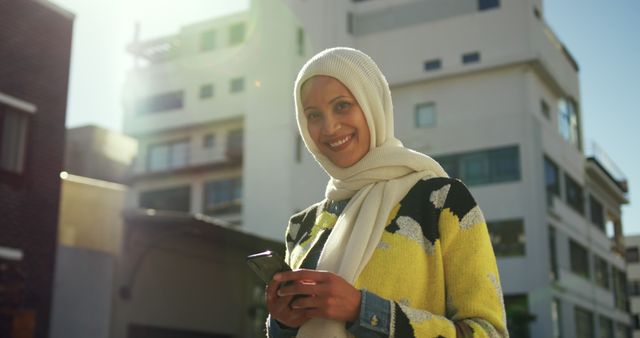 Smiling Woman with Hijab Using Smartphone Outdoors - Download Free Stock Images Pikwizard.com