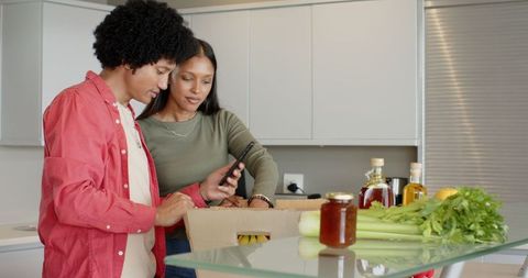 Couple Unpacking Groceries in Modern Kitchen for Healthy Living