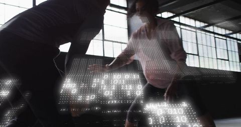 Sparring under backlit industrial windows with digital code projection