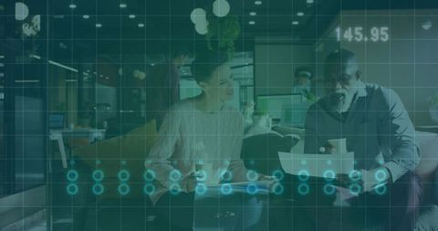 Coworking collaboration reviewing documents over coffee in lounge with digital data overlay