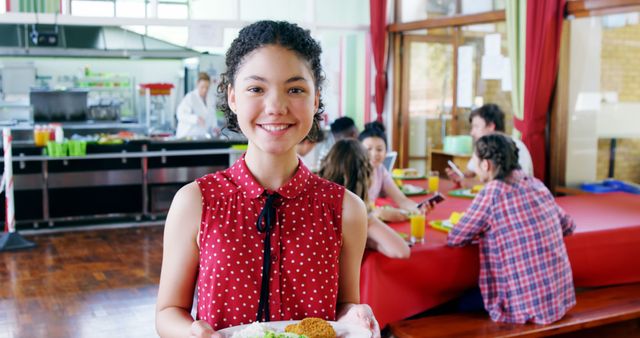 Cheerful Schoolgirl Holding Breakfast in Cafeteria - Download Free Stock Images Pikwizard.com