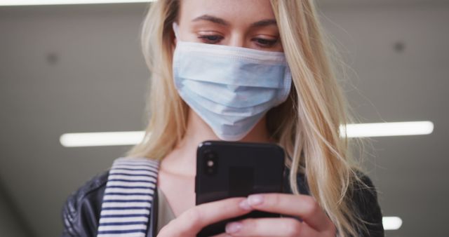 Young Woman in Protective Face Mask Using Smartphone - Download Free Stock Images Pikwizard.com