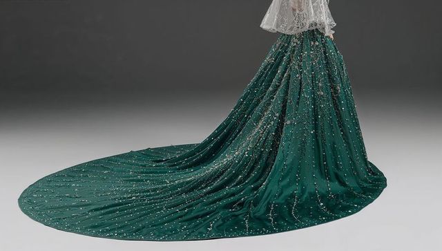 Emerald beaded couture gown featuring dramatic train and lace bodice, luxury eveningwear