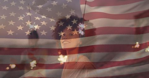 Joyful Independence Day Celebration with Sparkler and USA Flag Overlay