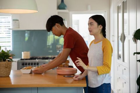 Asian Couple Cooking Together in Modern Kitchen Setting