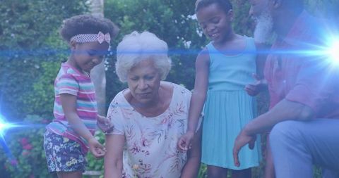 Senior woman gardening with grandchildren in sunlit backyard, multigenerational family bond