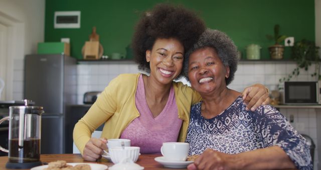 Loving African American grandmother and granddaughter enjoying coffee together - Download Free Stock Images Pikwizard.com