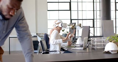 Businesswoman Using VR Headset in Modern Office for Innovation