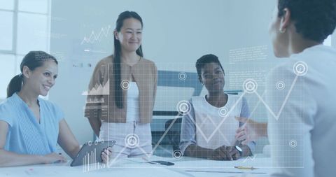 Businesswomen collaborating with digital analytics interface