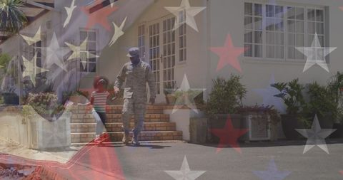 Soldier Father with Daughter Holding Hands in Front of USA Flag