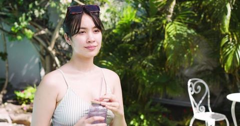 Woman Relaxing in Garden with Refreshing Drink